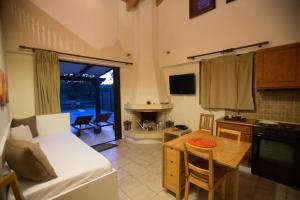a kitchen and living room with a couch and a table at 5 Stars Villas in Svoronata