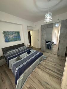 a bedroom with a large bed and a mirror at Solemar2 in Giardina Gallotti +2 photos