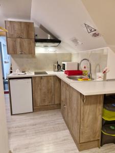 a kitchen with wooden cabinets and a sink at Zakątek DoriMaks in Zawoja