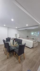 a dining room with a glass table and chairs at Feira Central Loft in Santa Maria da Feira