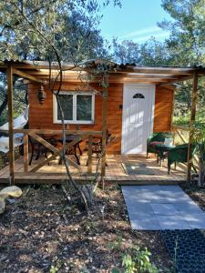a log cabin with a deck and a patio at Chez Eve 2 in Nîmes