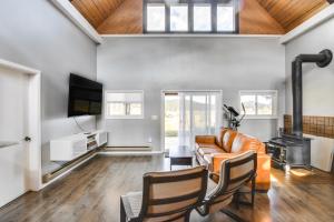 a living room with a couch and a fireplace at 5 Mi to Dtwn Evergreen Mtn-View Escape in Evergreen
