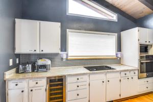 a kitchen with white cabinets and a window at 5 Mi to Dtwn Evergreen Mtn-View Escape in Evergreen