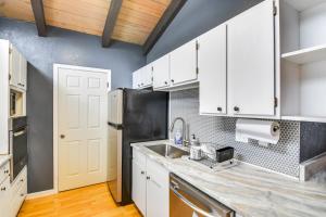 a kitchen with white cabinets and a stainless steel refrigerator at 5 Mi to Dtwn Evergreen Mtn-View Escape in Evergreen