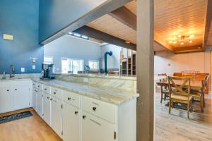 a large kitchen with white cabinets and a dining room at 5 Mi to Dtwn Evergreen Mtn-View Escape in Evergreen