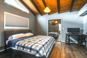 a bedroom with a bed and a desk and a television at 5 Mi to Dtwn Evergreen Mtn-View Escape in Evergreen