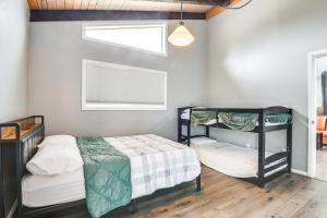a bedroom with two bunk beds and a window at 5 Mi to Dtwn Evergreen Mtn-View Escape in Evergreen