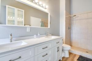 a bathroom with a sink and a toilet and a mirror at 5 Mi to Dtwn Evergreen Mtn-View Escape in Evergreen +18 photos