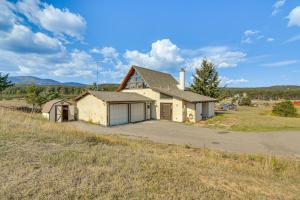 an old house in the middle of a field at 5 Mi to Dtwn Evergreen Mtn-View Escape in Evergreen