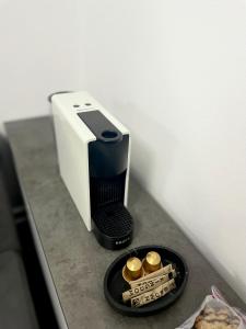 a toaster sitting on a counter next to a box of cigarettes at Nubia Modern Apartment in Craiova