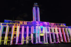 a building with colorful lights on it at night at Charming Flat in Villeurbanne Gratte-Ciel in Villeurbanne