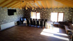 a living room with a table and chairs and a couch at Alpin Chalet in Rucăr