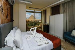 Postelja oz. postelje v sobi nastanitve Pyramids Palace INN