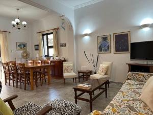 a living room with a table and a dining room at Kato Panayia Cafe Retreat in Káto Panayía