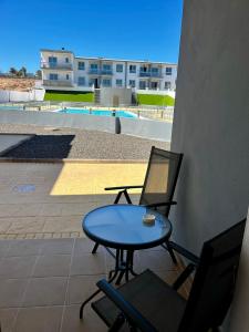 un patio con tavolo e sedie e un edificio di Casa Oti en Roque del Mar a Costa de Antigua