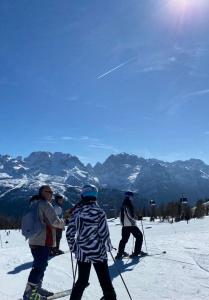 a group of people on skis in the snow at Palazzo Tof in Bocenago +14 photos