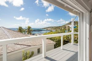 a balcony with a view of the ocean at Le Spot - Unique house with view in Oyster Pond