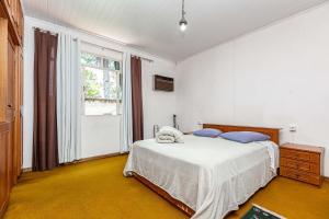 Postel nebo postele na pokoji v ubytování Memora Guesthouse Curitiba - Quartos em Casa próximo ao Parque Bacacheri