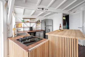a kitchen with a wooden counter top in a room at Le Spot - Unique house with view in Oyster Pond