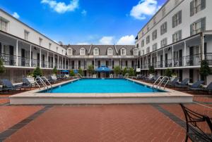 a swimming pool in the courtyard of a building at The Royal Sonesta New Orleans in New Orleans