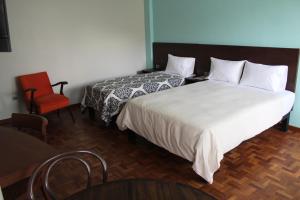 Postel nebo postele na pokoji v ubytování Kunan Hotel