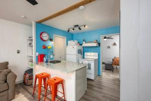a kitchen with a counter and orange stools in it at Skyes Hideaway Walk to Lifts in Angel Fire