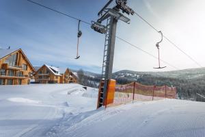 a ski lift on a ski slope in the snow at Aldrov Resort in Vítkovice