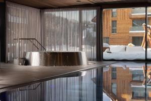 a metal tub in a room with a reflection in the water at Aldrov Resort in Vítkovice