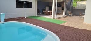 a house with a swimming pool and a patio at Conforto em Pomerode in Pomerode