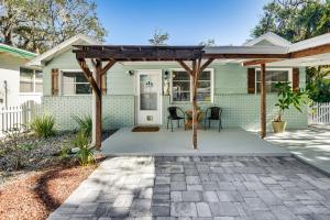 a home with a pergola on a patio at Dog-Friendly Daytona Beach Cottage with Patio! in Daytona Beach