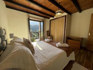 a bedroom with a large bed with a large window at Casa Las Hortensias 2 Pendueles in Llanes