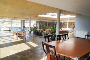 a room with tables and chairs in a building at Camí Romà in Albiol