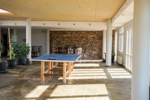 a ping pong table in a room with a brick wall at Camí Romà in Albiol