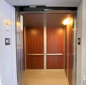 a wooden elevator door in a building at Downtown, contemporary, 2 bedroom, Roof Terrace! 4A in Savannah