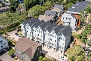 an overhead view of a large white building with gray roofs at On the Move in Plaza Midwood in Charlotte