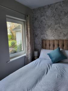 A bed or beds in a room at Beech lodge