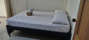 a small bed with a box on top of it at Casa central, segundo piso in Norcasia +4 photos
