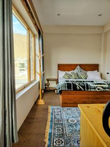 a bedroom with a bed and a window at Gawa Residency in Leh +25 photos