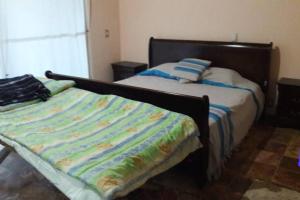 En eller flere senge i et værelse på Casa Alce