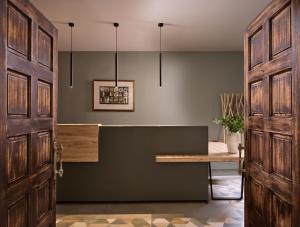 an open door leading into a kitchen with a table at AQUARIUS HOTEL in Vasilikos