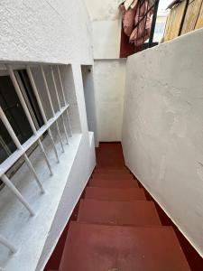 an empty hallway with a staircase in a building at Hotel Nativo in Santiago