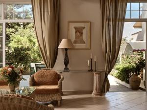 a living room with a chair and a lamp at AQUARIUS HOTEL in Vasilikos