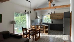 a kitchen and dining room with a table and chairs at Apartmán Wood in Ostravice