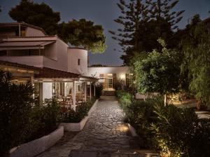 a walkway leading to a house at night at AQUARIUS HOTEL in Vasilikos