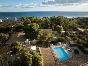 an aerial view of a house with a swimming pool and the ocean at AQUARIUS HOTEL in Vasilikos