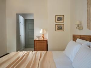 a bedroom with a bed and a lamp on a table at AQUARIUS HOTEL in Vasilikos