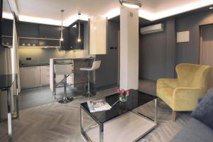 a living room with a couch and a table at Apartamenty Zamenhofa in Białystok +13 photos