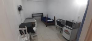 a room with a room with a table and a tv at Avenida colon in Santiago del Estero