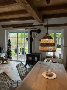 a dining room with a large wooden table with chairs at Haus am See Kamin privater Seezugang in Warendorf