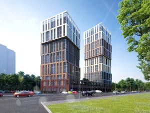 two tall buildings next to a parking lot with cars at ApartPlus - Затишні апартаменти in Dnipro